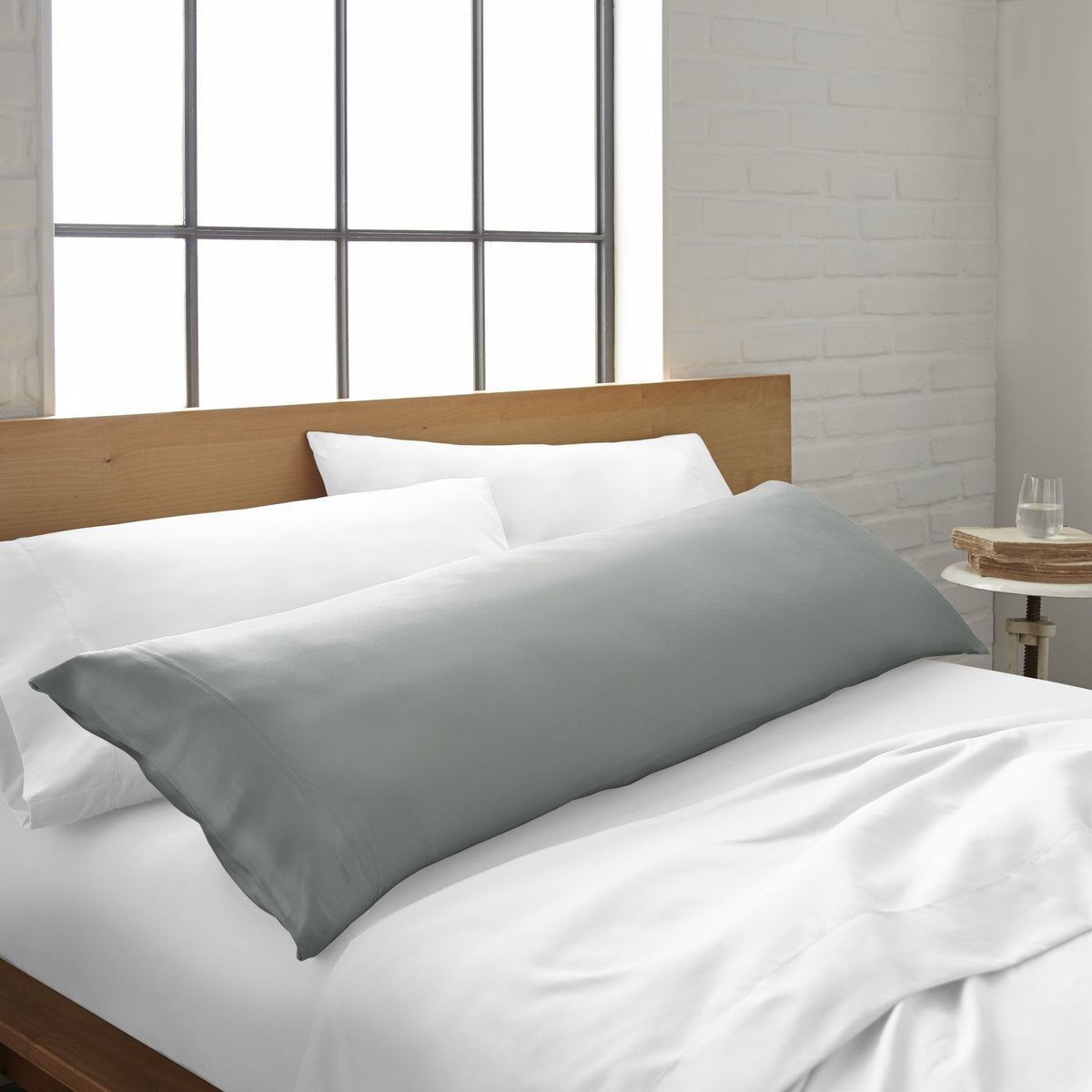 Cooling bamboo body pillowcase by Bamboo is Better, shown on a bed with a silver finish and smooth, breathable fabric.