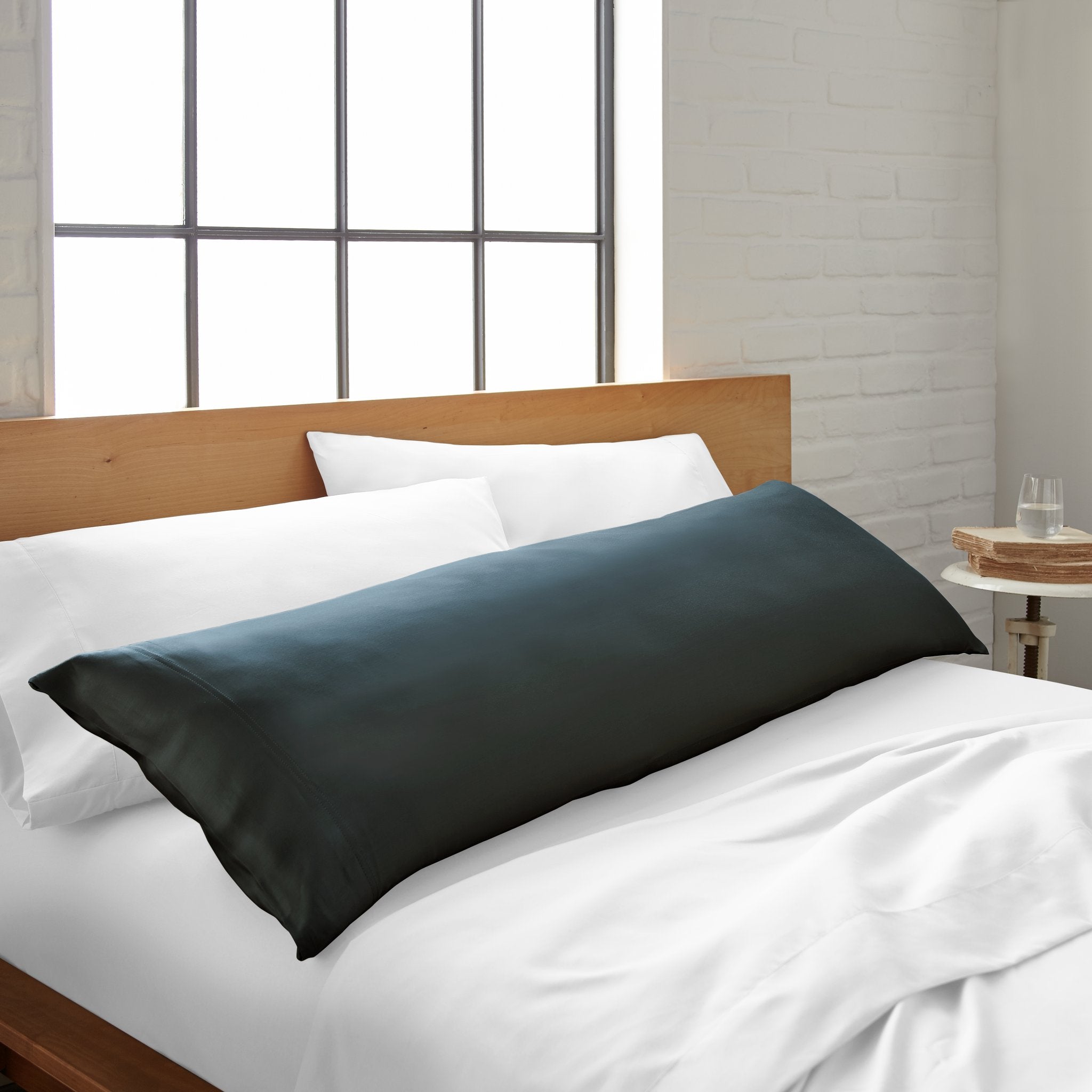 Cooling bamboo body pillowcase from Bamboo is Better, featuring a sleek slate color, shown on a bed with matching bedding.